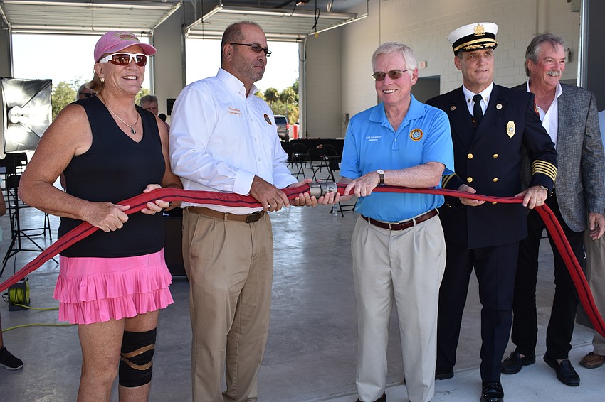 At-Large Commissioner BJ Bishop, Town Manager Tom Harmer, Mayor Ken Schneier, Fire Chief Paul Dezzi and Vice Mayor Mike Haycock partake in the uncoupling of the firehose.