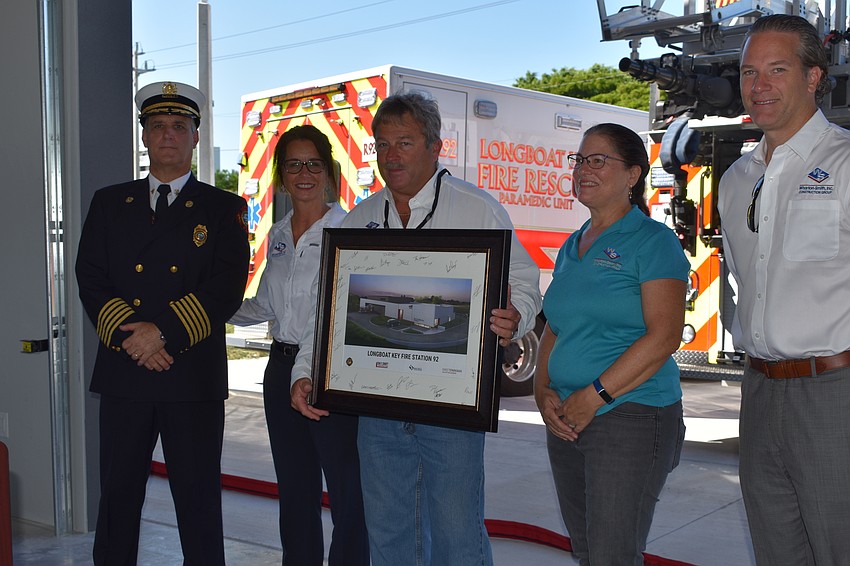 Fire Chief Paul Dezzi poses for a photo with Wharton-Smith Inc. workers Caryn Huff, Doug Whisler, Jennifer Newman and Tom Iarossi.