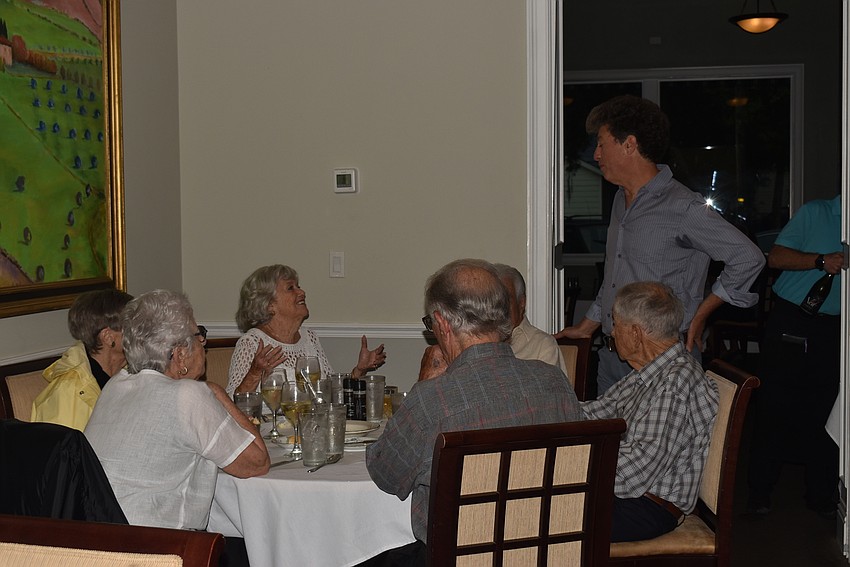 Members chatted with the others at their table while waiting for dinner.