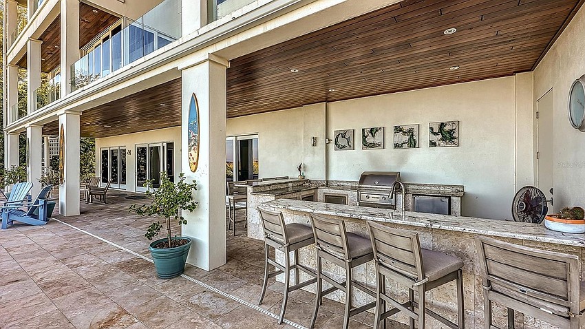The pool area features a summer kitchen.