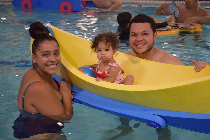 Parrish's Alexa Martinez has fun watching her 1-year-old daughter Madeline James sit in a boat being lightly rocked by her husband James Martinez.