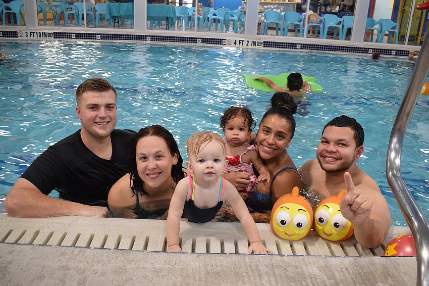 Parrish's Trevor Cutlip, Robyn Lebuffe and 1-year-old Averie Cutlip spend time with Parrish's 1-year-old Madeline Martinez and her parents, Alexa and James Martinez during the family swim and screen at Goldfish Swim School.