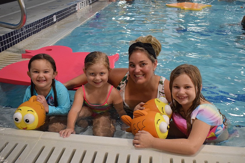 Ellenton's Paige Ryan, who is 4, plays in the pool with 5-year-old Madeline Ryan, Emily Ryan and 7-year-old Ryleigh Byre.