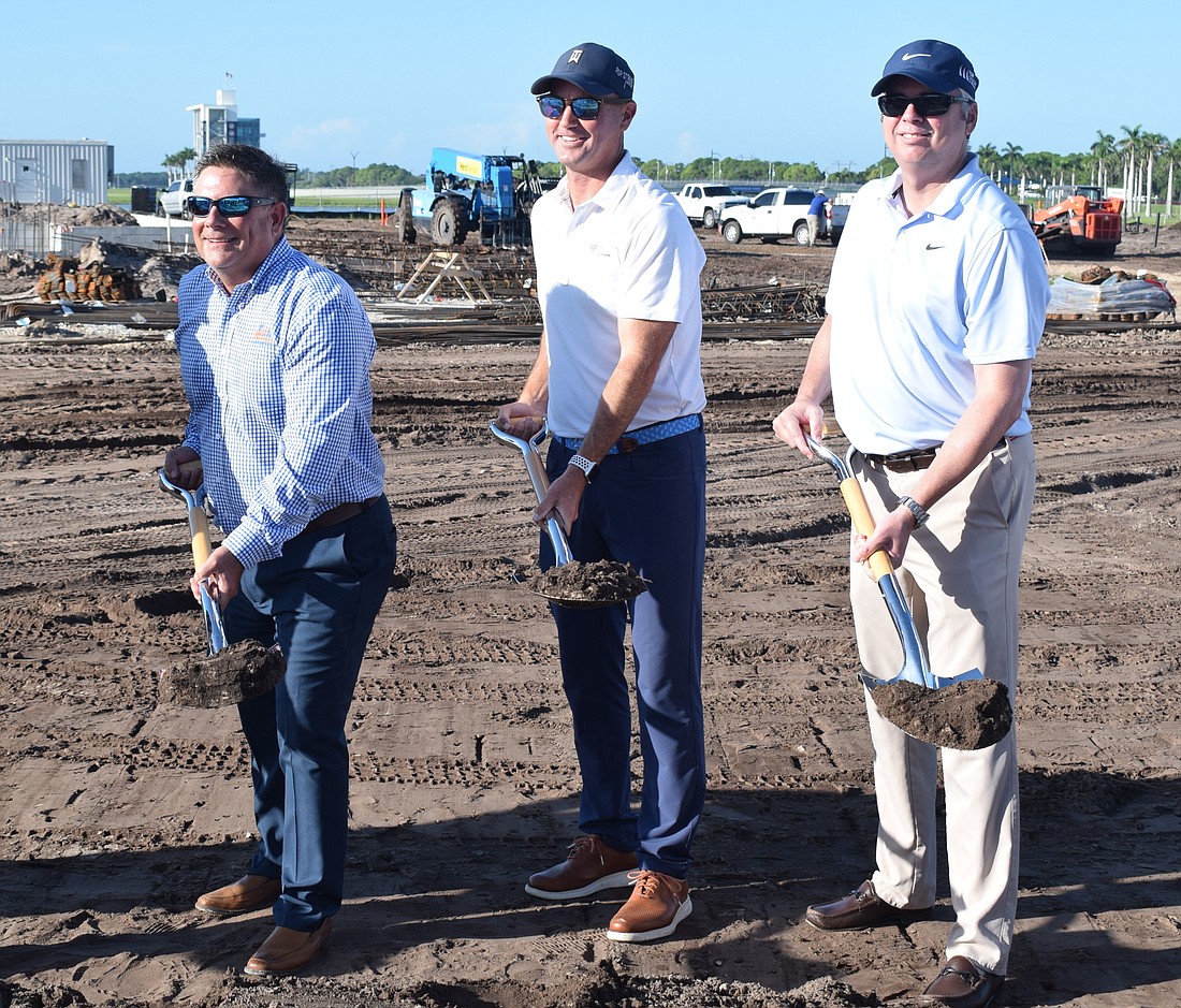 Mark Stevens, president of Stevens Construction, Greg Bartoli, PopStroke founder, and Bryon Bell, president of TGR Design, get busy with shovels at the PopStroke groundbreaking at UTC in Sarasota.