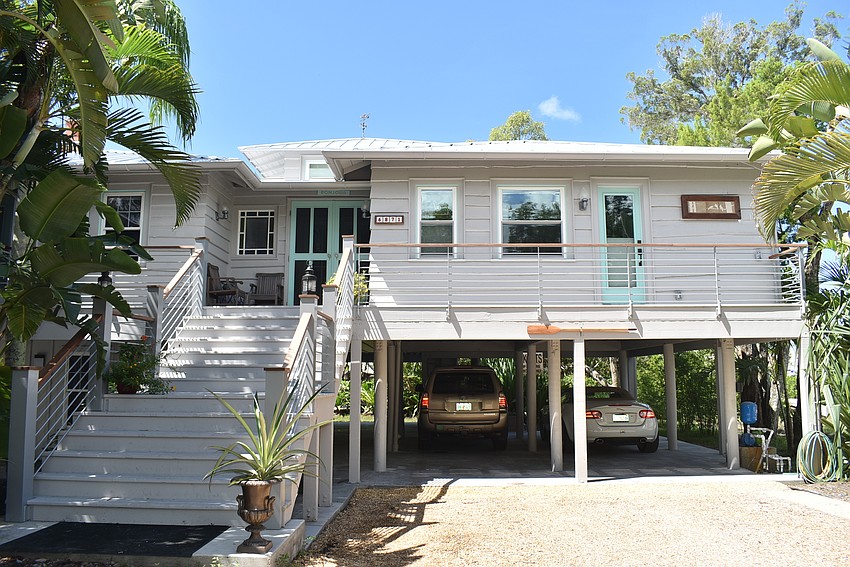 The home is set back from the road and shrouded in trees.