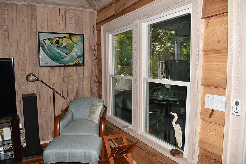 The window in the living room looks out over mature palms, giving it a treehouse feel.