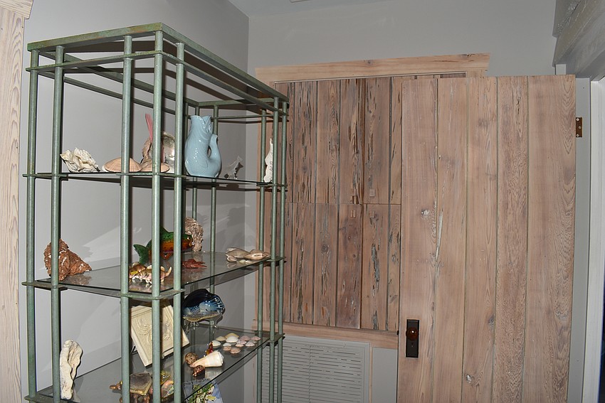 The Prices kept as much of the cypress as possible and used it around the house, like in this door.