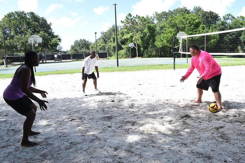 Lakewood National's Ghyslaine and Leslie McBean learn the basics of volleyball from Chris McComas with Lakewood Ranch Community Activities.