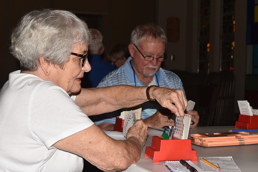 Lynn Nieting flips through her bidding box.