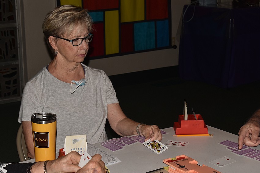 Carilyn Reiter flips a card for a play.