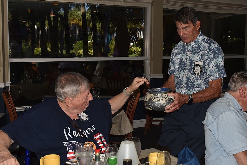 John Wild drops in happy dollars to Jim Larson.