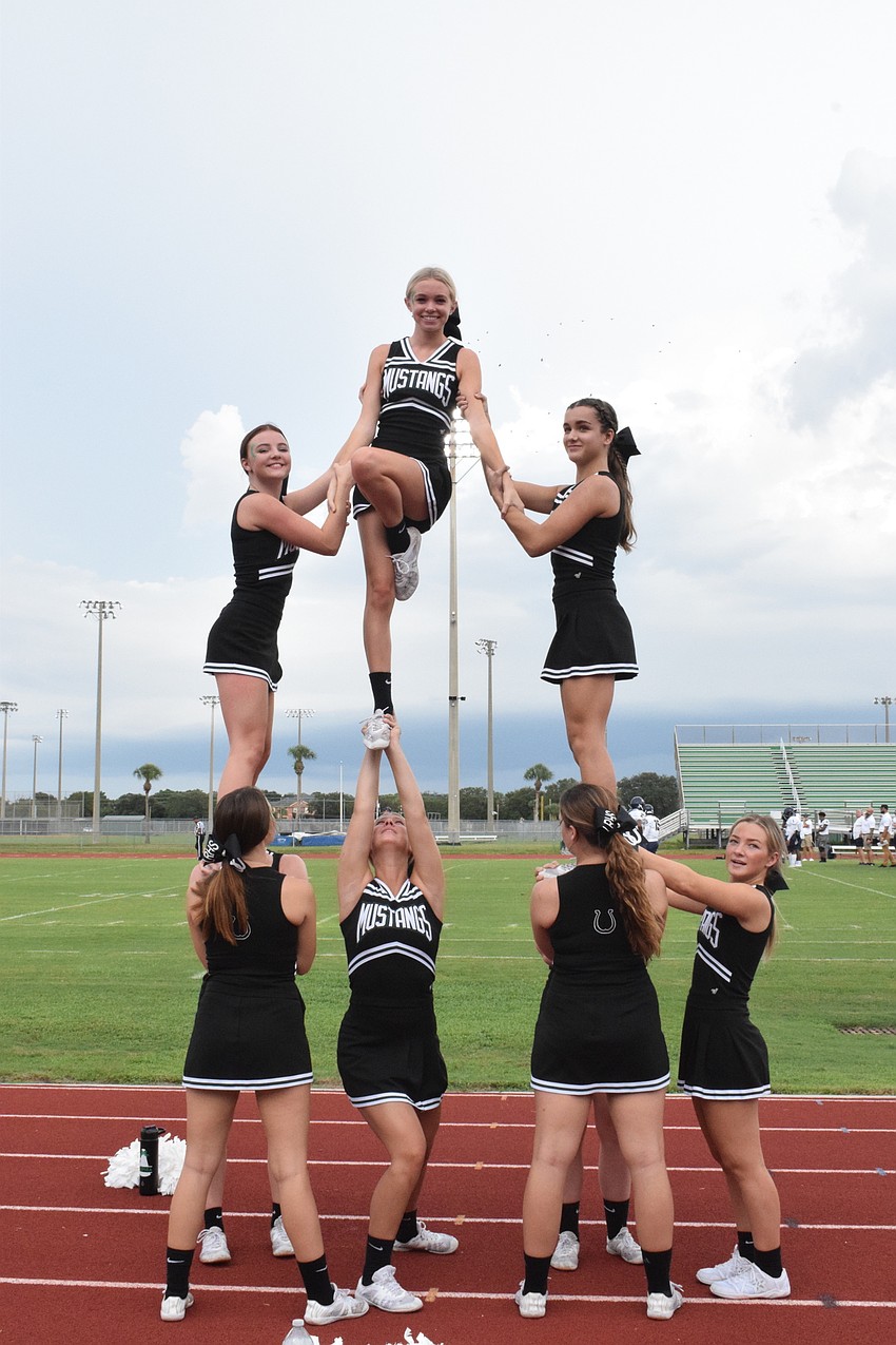 Lakewood Ranch High School cheerleaders complete a stunt.