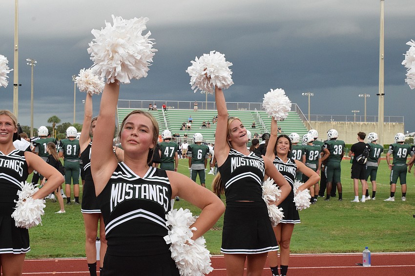 Eden Gibbs, Rain Hanson and Cami Sablan are in unison as they chant as loud as they can to be heard over the crowd.