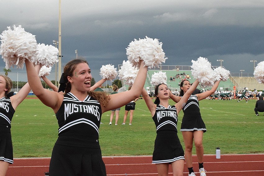 Kennedy Burnette, Alyssa Ucciferri and Skyla Alonso have fun cheering for the football team.
