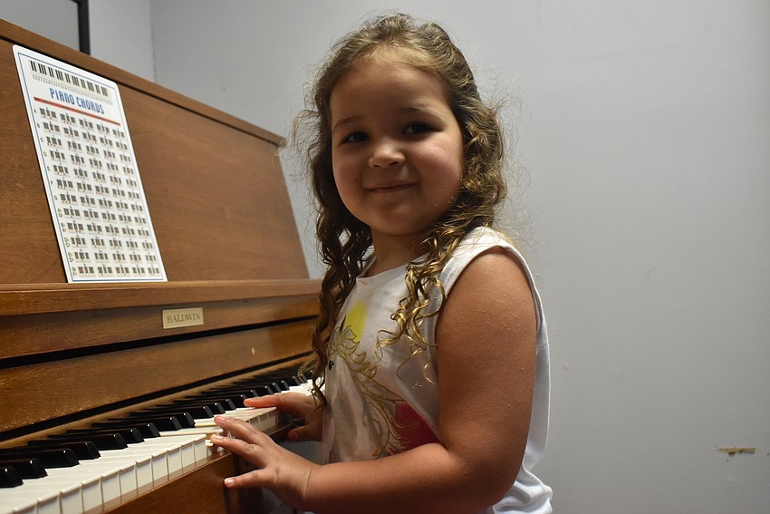 Ellie LaChapelle tries out the piano.