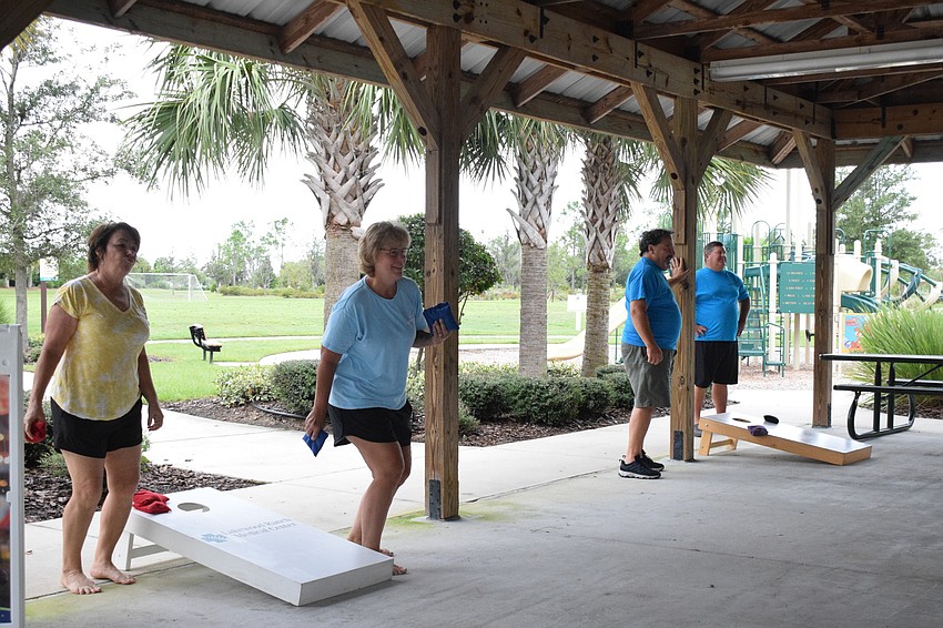Lakewood Ranch's Carolyn Ray, Kelly Harmon, Marty Saia and Mike Harmon enjoy Lakewood Ranch Community Activities' casual cornhole.