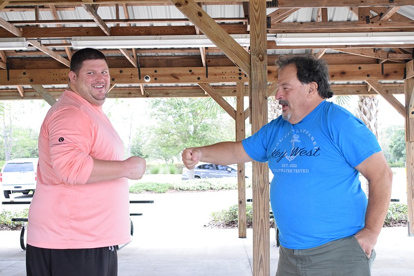 Chris McComas with Lakewood Ranch Community Activities fist bumps Lakewood Ranch's Marty Saia to celebrate their win.