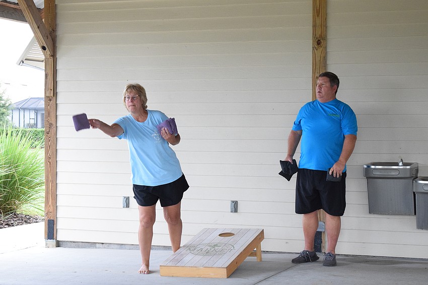 Lakewood Ranch's Kelly Harmon competes against her husband, Mike Harmon, in a game of women versus men with Lakewood Ranch's Mollie and Marty Saia.