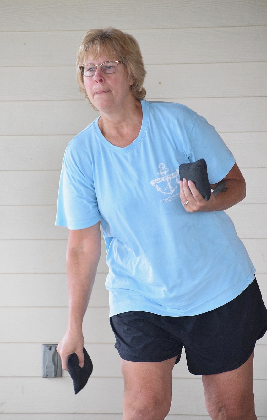 Lakewood Ranch's Kelly Harmon goes for a bag in-the-hole to score three points.