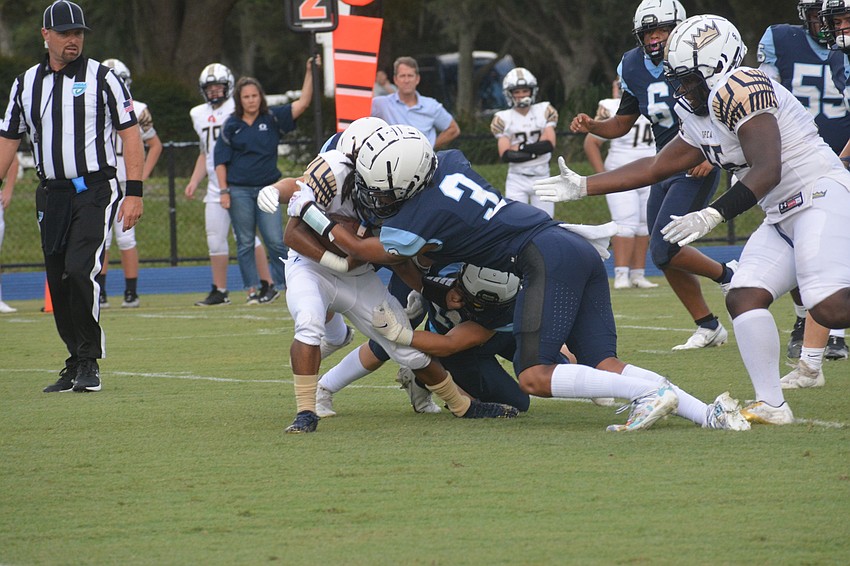 ODA freshman Greg Robinson (3) lays a hit on Southwest Florida Christian running back Santavious Gadsden.
