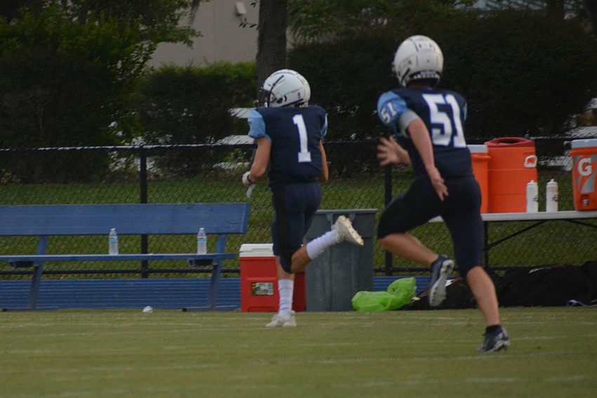 ODA junior Ashton Lamb (1) returns an interception out of the end zone as freshman Kyler Stidd (51) sprints to get a block.