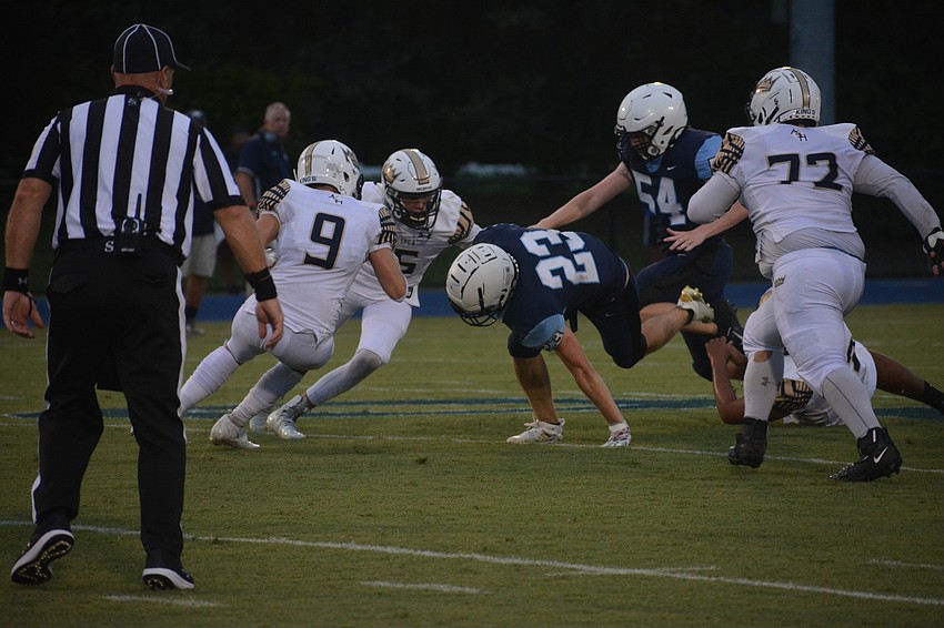 ODA senior running back Grady Paxton (23) uses his hand to stay on his feet and pick up a few more yards.