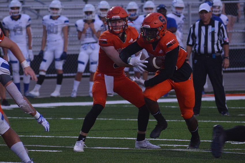 Lance Trippel hands off to Jarmel Holloway.