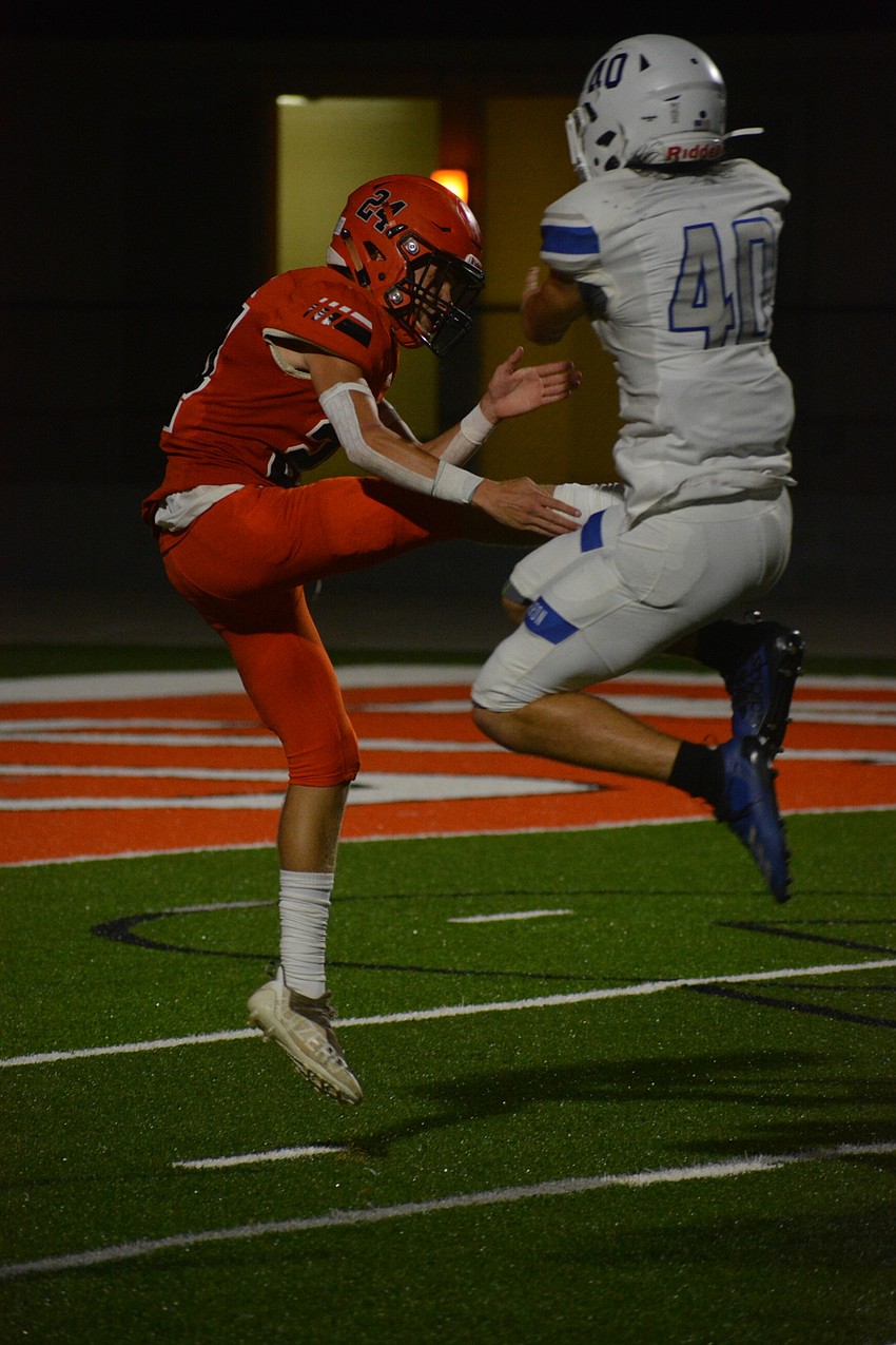Sailors punter Chase Mattila gets roughed by Barron Collier's Josh Guitard.
