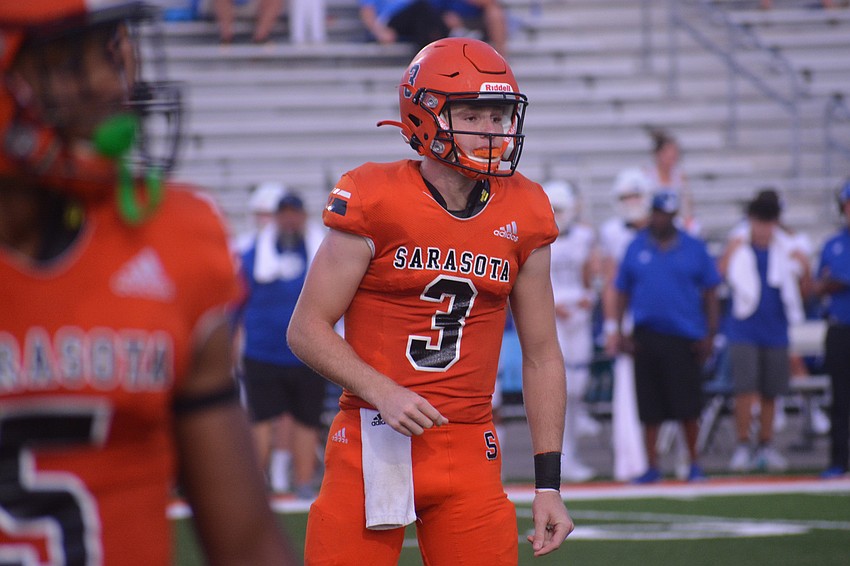 Sailors quarterback Lance Trippel looks to the sideline for the play call.