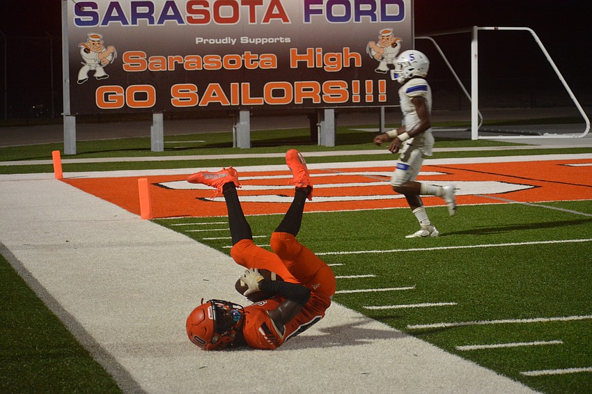 Sailors wideout T.J. McKay falls out of bounds after catching a deep pass from Lance Trippel.