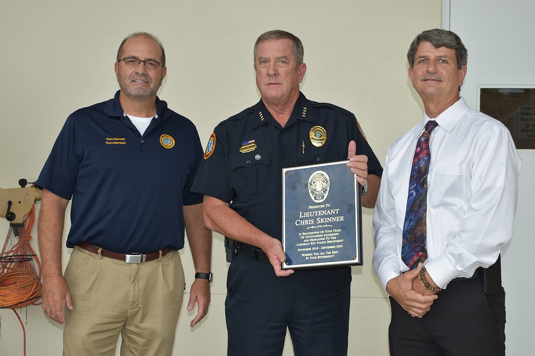 Town Manager Tom Harmer and Interim Police Chief George Turner thanked Lt. Chris Skinner for his contributions to the Longboat Key Police Department. They presented Skinner with a commemorative plaque on Wednesday afternoon.