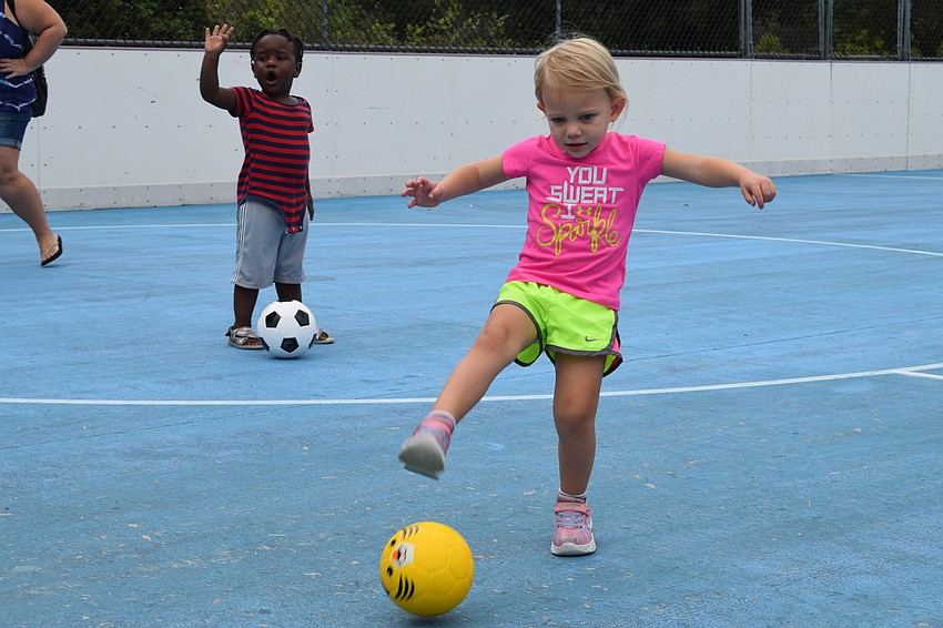 Lakewood Ranch's Az Fortune, who is 2, watches Josie McComas, who is 2, try to score a goal.