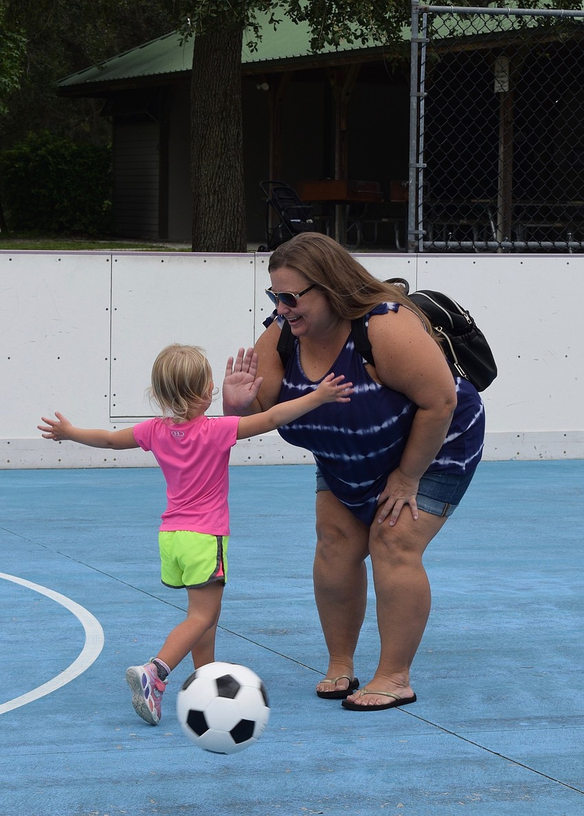 Lakewood Ranch's Josie McComas, who is 2, runs to hug her mother, Jessi McComas, after she scores a goal.