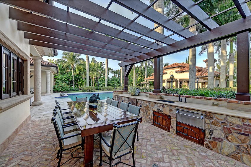 The outdoor entertaining area features an extended sundeck surrounding the heated saltwater swimming pool and raised spa, covered dining and lounge area.
