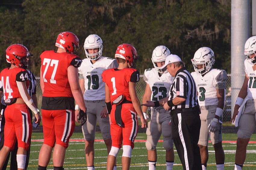 Cardinal Mooney captains J.R. Rosenberg, Theodore Barton and Tayven Clark stand with Lakewood Ranch captains Drew Clark, Marlowe Walker,  Kevin Everhart and Cameron Madison.