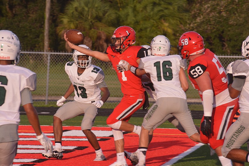 Cardinal Mooney senior quarterback Tayven Clark reaches over the goal line for a touchdown on a designed run.
