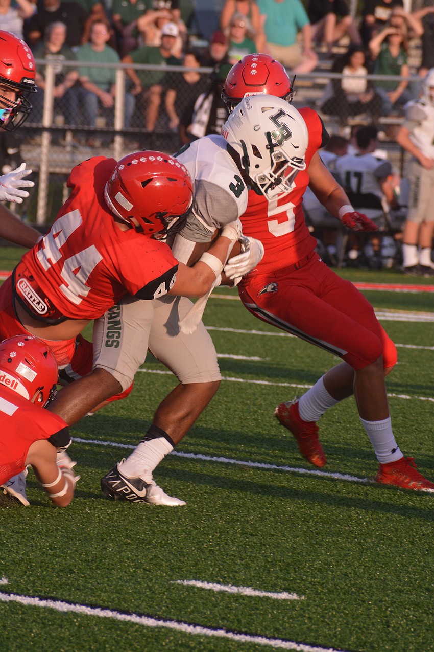 Cardinal Mooney junior J.R. Rosenberg (44) tackles Lakewood Ranch junior Kevin Everhart after a nice gain.