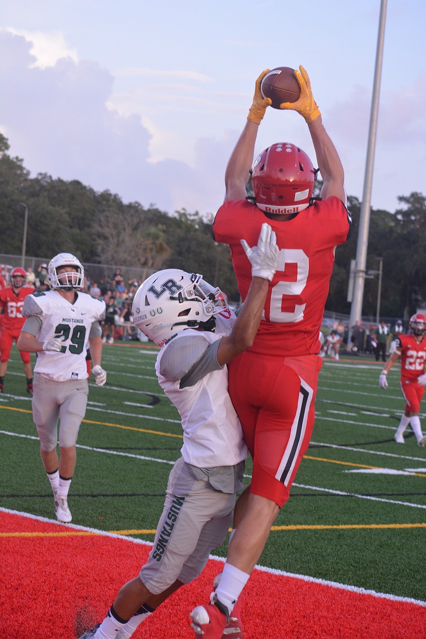 Cardinal Mooney senior wide receiver Cooper Flerlage leaps over Lakewood Ranch sophomore Jayden Munoz for an attempted touchdown catch. The catch would be ruled out of bounds.