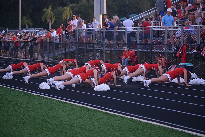 The Cardinal Mooney cheerleaders do a push up for every point the Cougars score.