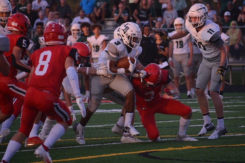 Lakewood Ranch junior running back Kevin Everhart bursts through the Cardinal Mooney defensive line.