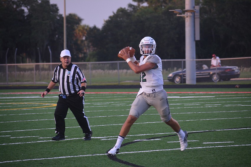 Lakewood Ranch senior quarterback Cameron Madison throws on the run.