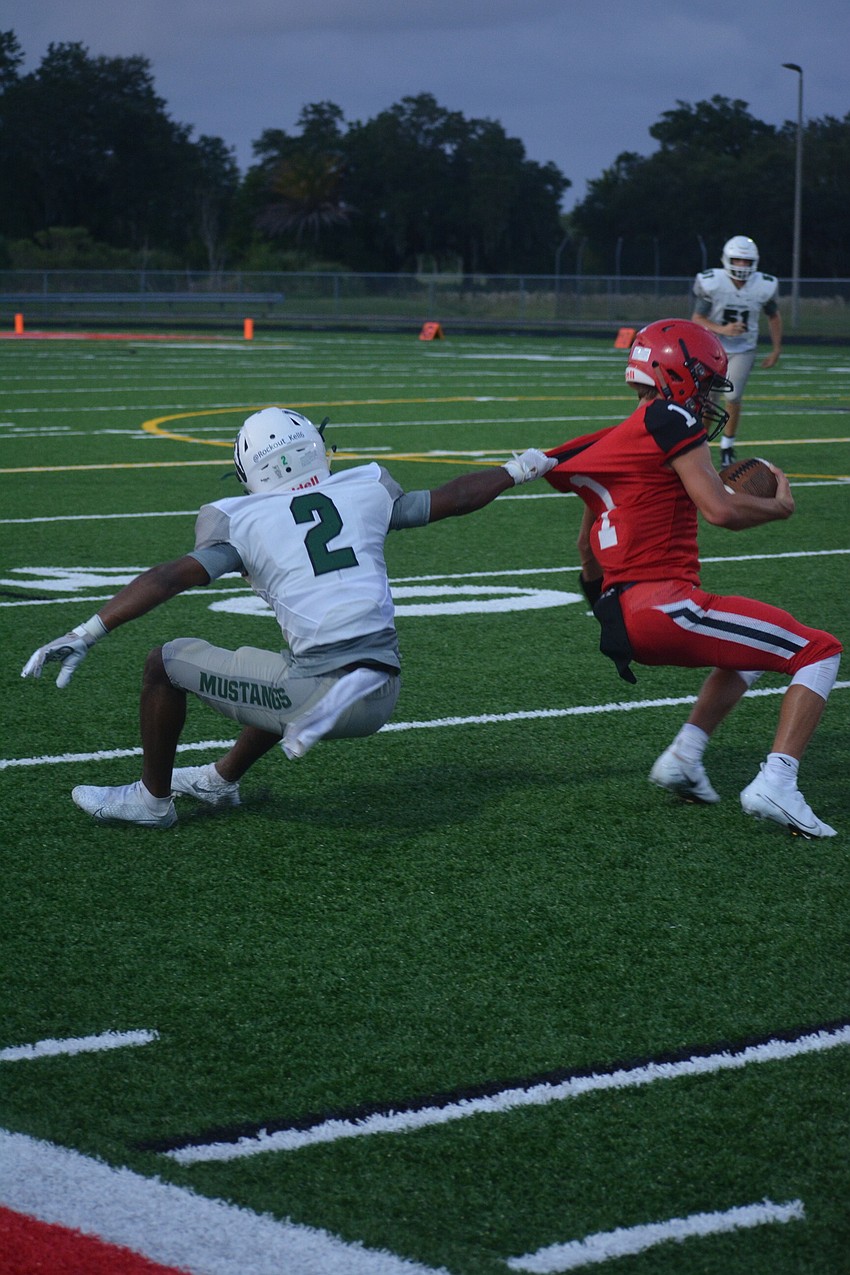 Lakewood Ranch junior defensive back Dior Keys pulls Cardinal Mooney quarterback Tayven Clark down with a horse collar tackle. Keys was penalized for the tackle.