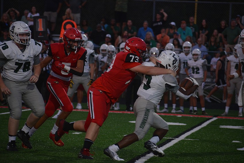 Cardinal Mooney sophomore Ryan Sugg wraps up Lakewood Ranch junior Kevin Everhart and forces him backwards.