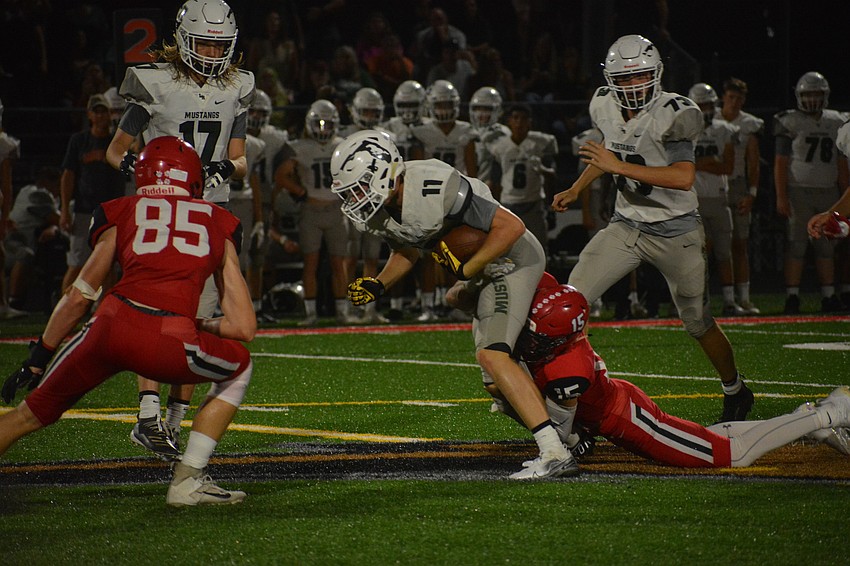Cardinal Mooney junior Kyle Cooke (85) preps to put a hit on Lakewood Ranch wideout Isaac Ashley.
