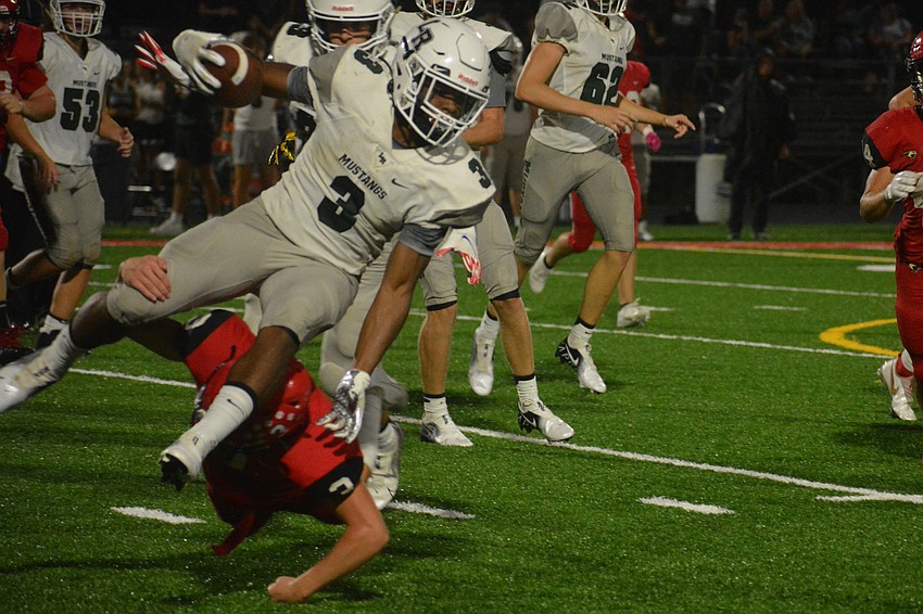 Lakewood Ranch junior Kevin Everhart is upended by Cardinal Mooney sophomore Griffin Gisotti.