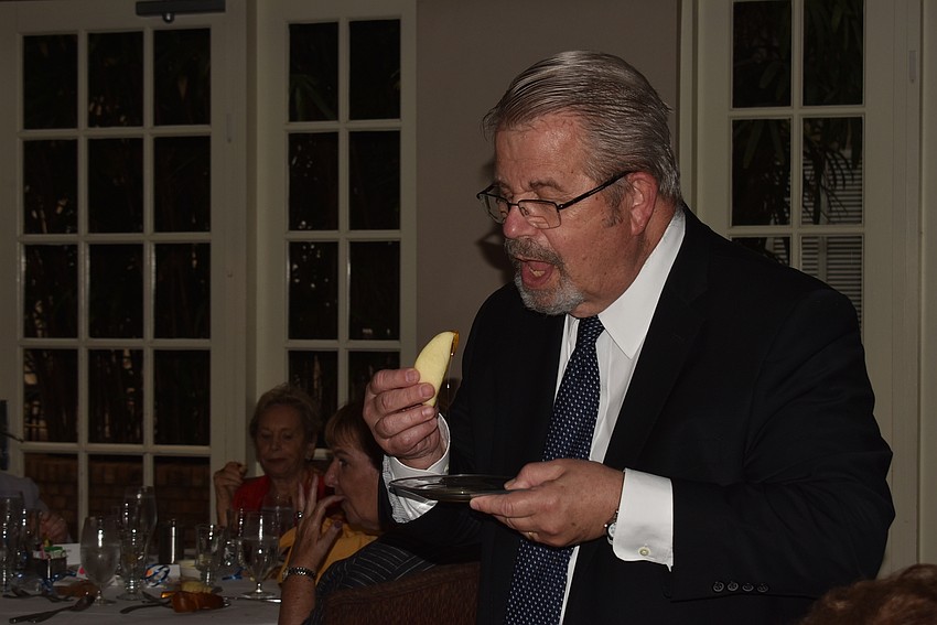 Rabbi Stephen Sniderman takes a bite of apple with honey after blessing them.