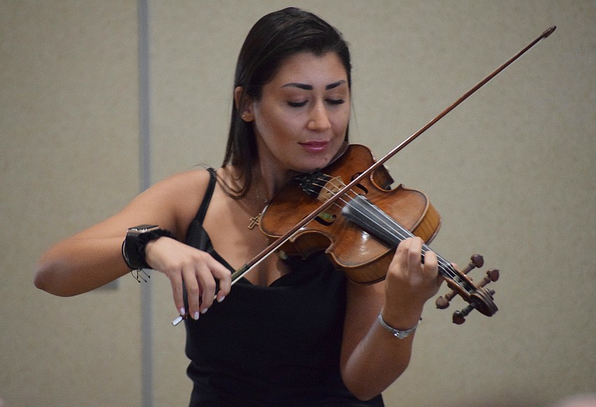Alisa Darbinyan plays the first piece of the Golden Gates of Armenia's performance with three other violinists.