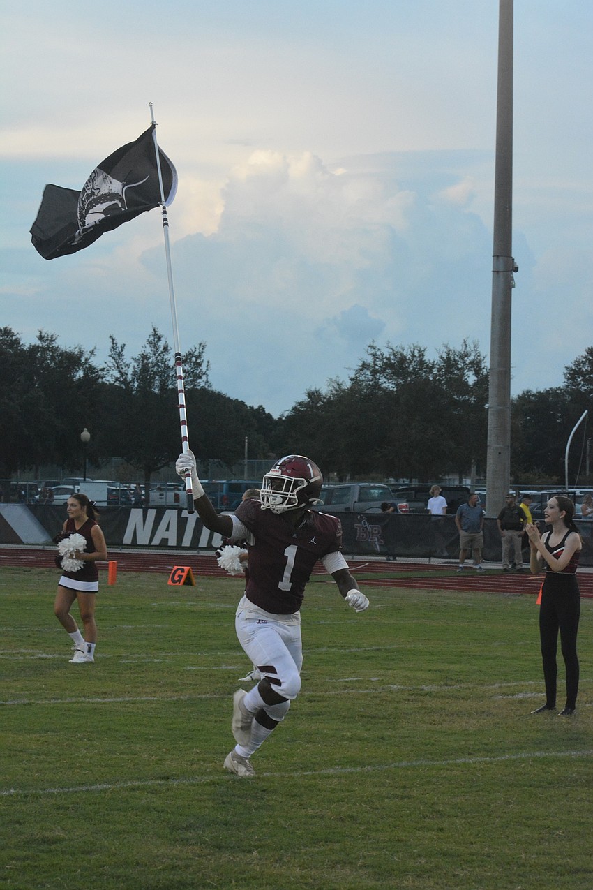 Senior running back Justice McDaniel leads the Braden River football team onto the field.