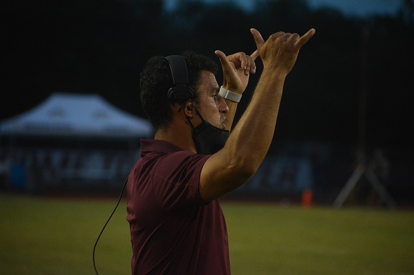 Braden River Coach Curt Bradley signals in a play to his defense.