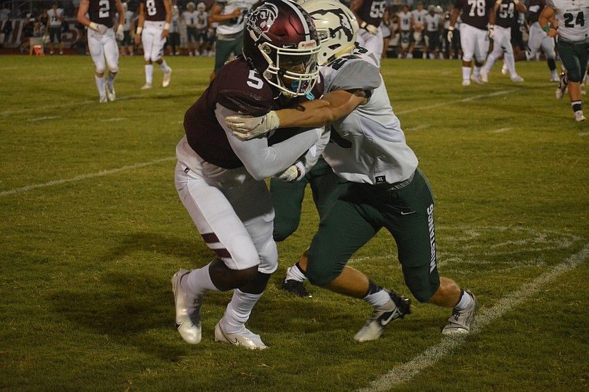 Braden River wideout Bryan Kearse is shoved out of bounds by Lakewood Ranch linebacker Anthony Cummings.